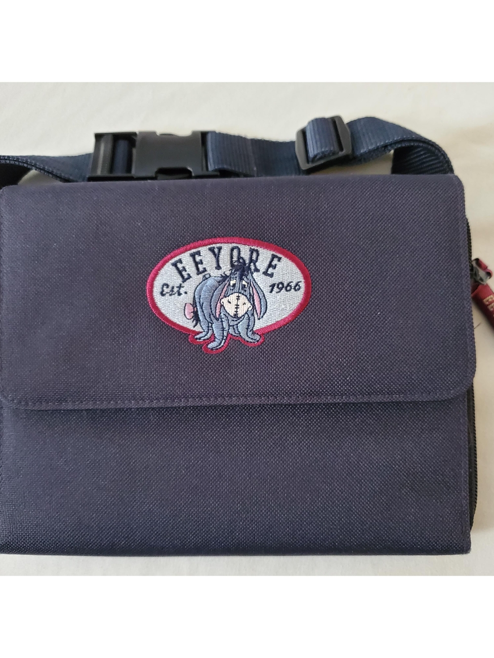 This is a vintage Disney Store Eeyore black canvas fanny pack.